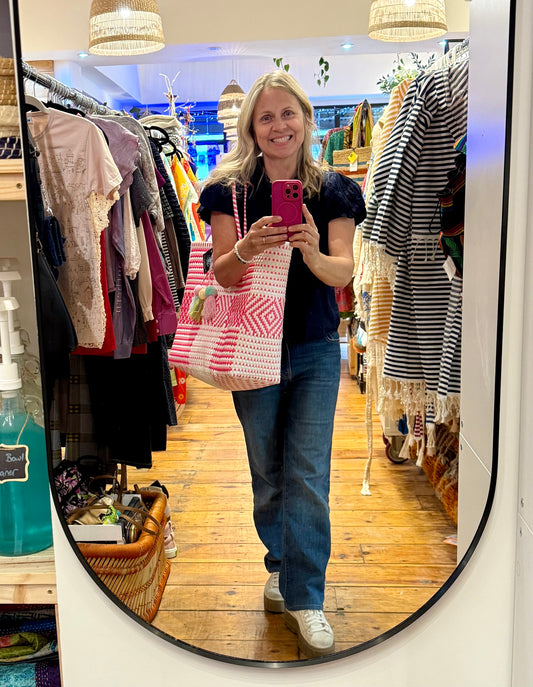 Handcrafted tote made from 100% recycled plastic. Pom included